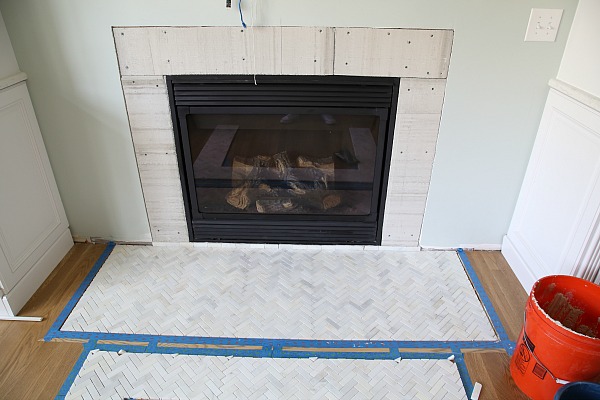 Upgrade your fireplace in a weekend! Get a step by step tutorial on how to install a marble herringbone fireplace surround and hearth.