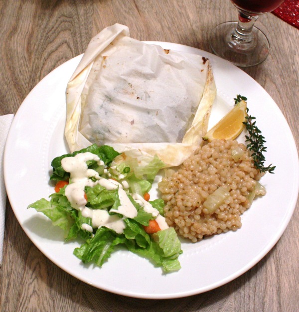 Baked seafood in parchment with pearled couscous