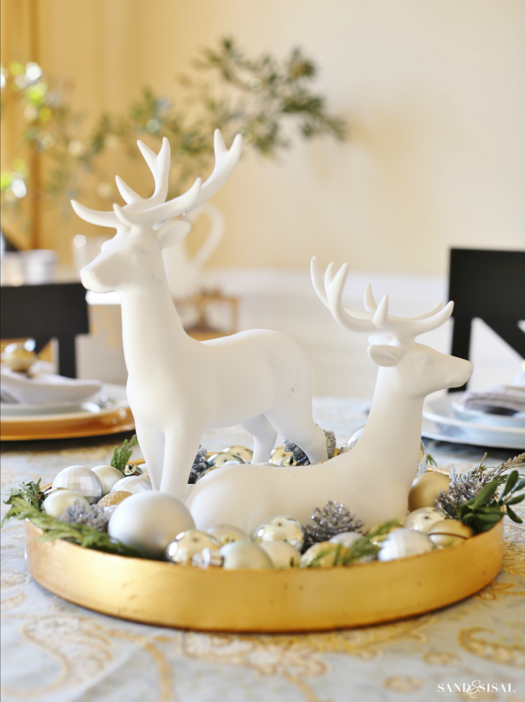 Christmas Reindeer Centerpiece - Super simple! Fill a tray with greens, ornaments and 2 reindeer statues. You can make it in less than 5 minutes!