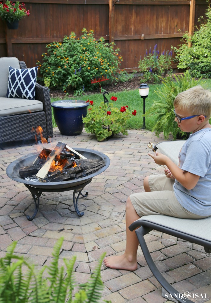 Toasting s'mores - see that outdoor lighting? It has built in mosquito repellent! So cool!