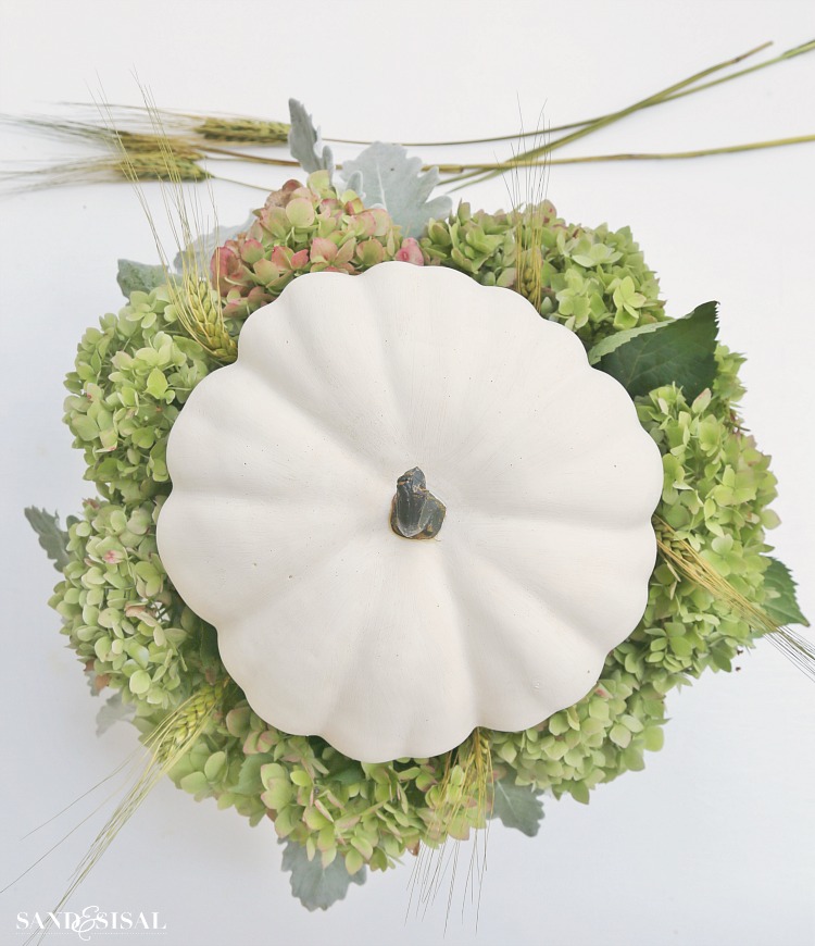 step-4-insert-wheat-straw-and-pumpkin. White Pumpkin and Hydrangea Fall Centerpiece